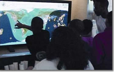 Boy touches the Seismic Monitor screen
